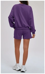 Rear view of purple women's sports set featuring sweatshirt and shorts with back pocket