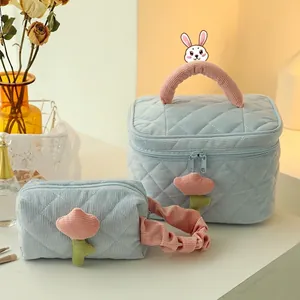 Quilted corduroy makeup bag set in light blue with pink handles and tulip zippers