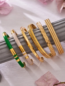 Set of six gold-plated open bangles featuring enamel details and textured metal finishes