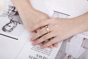 Detailed close-up of a 6mm round zircon titanium steel ring on a model's hand