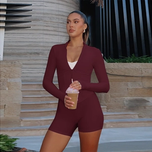 Detail view of burgundy long sleeve rompers with a functional zipper neckline