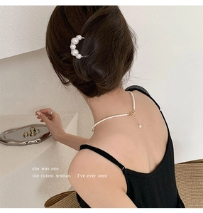 Close-up of U-shaped hair pin with gradient pearls and a matching pearl necklace set
