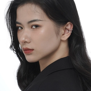 Minimalist S925 sterling silver triple layer spiral ear cuff shown on a model ear