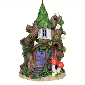 Detail of whimsical fairy tree house garden decor with purple door and red mushrooms
