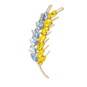 Elegant gold wheat ear brooch featuring blue and yellow crystal marquise stones