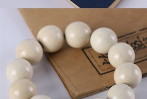 Macro shot of ivory nut prayer beads showing natural concentric circular textures