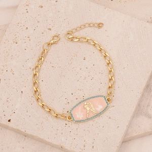 Macro shot of gold rectangle Aquarius pendant with pink enamel and blue crystals
