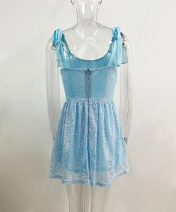Detail of light blue sequin dress back featuring hidden zipper and satin bow straps