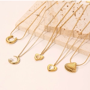 Collection of gold necklaces with cat's eye stone, pearls and horse shoe pendants
