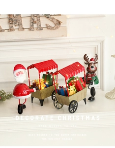 Détail du décor de Noël en fer illuminé avec traîneau rouge, Père Noël et renne