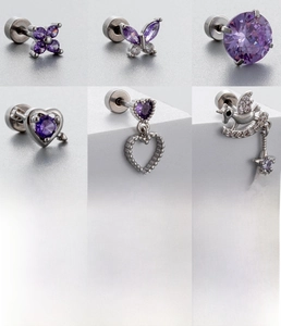 Detailed view of six purple zircon studs including butterfly and heart designs on titanium steel