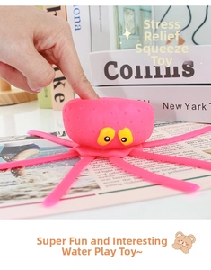 Close-up of hand squeezing a pink silicone octopus toy showing soft texture for bath time