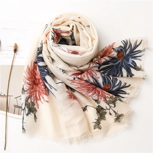 Detailed macro view of beige cotton linen scarf with elegant red and blue floral prints