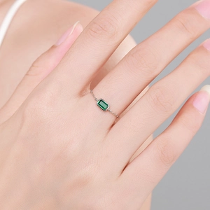 S925 sterling silver ring with rectangular green zircon on finger model's hand
