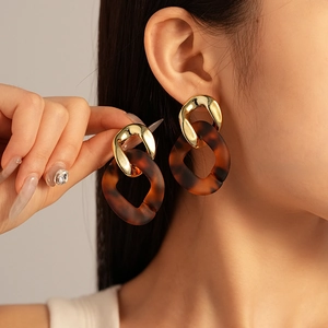 Vintage acrylic leopard print geometric oval earrings with gold metal link on model
