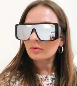 Close-up of flat top oversized sunglasses with silver mirrored lenses on model