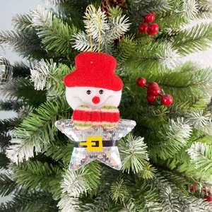 Close-up of a snowman and silver sequined star ornament hanging on a Christmas tree