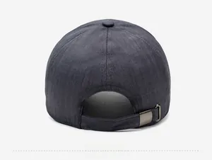 Detail view of dark grey baseball cap featuring adjustable metal buckle and textured fabric