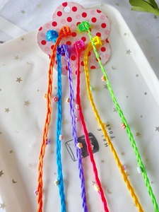 Colorful braided hair clips for girls with floral accents and beads on pink card