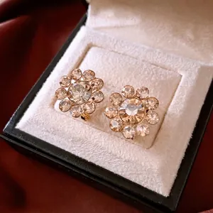Elegant 14K gold plated flower stud earrings with crystals in a luxury jewelry box