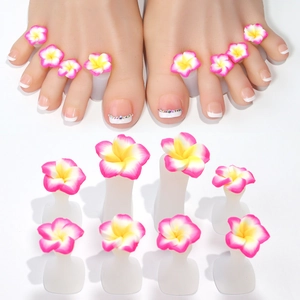 Detail view of silicone toe separators with daisy flower designs for nail art pedicure