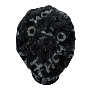 Detail of charcoal black knit beanie featuring vintage distressed texture and letter prints