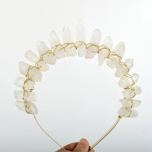 Detail of natural raw white quartz crystals hand-wrapped with gold wire on a headband