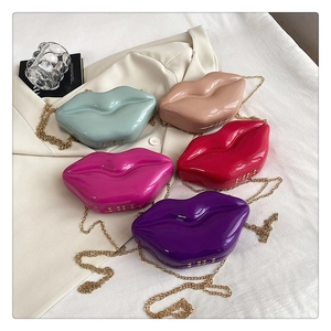 Detailed view of glossy lip-shaped box bags in five colors with gold chains and rivets
