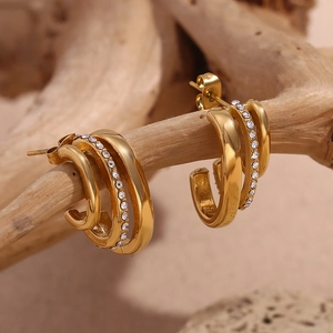 Macro shot of 18K gold plated triple-layer C-shape earrings with sparkling cubic zirconia