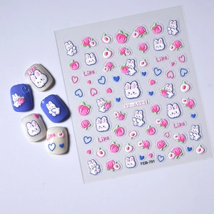 Detail showing 5D embossed rabbit and peach nail art stickers with 3D texture effect