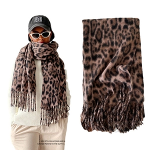 Leopard print pashmina scarf with fringe edges styled with a black embroidered baseball cap