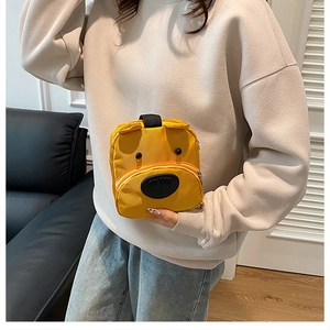 Close-up of yellow cartoon puppy handbag featuring 3D ears and black button eyes