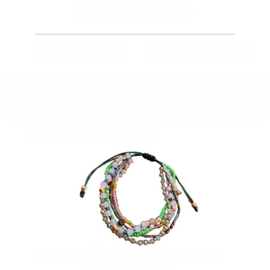 Detail view of handmade multi-layer beaded bracelet with green cord and crystal beads