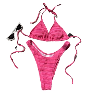 Two-piece hot pink textured bikini with drawstring ties and high-cut bottom