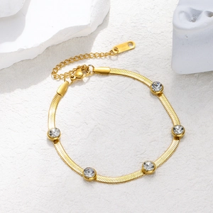 Detailed view of a gold snake chain bracelet with five bezel-set zircon stones
