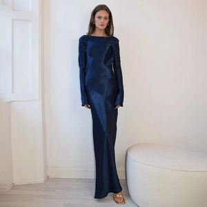 Close-up of elegant dark blue satin dress showing luxurious fabric texture and slit detail