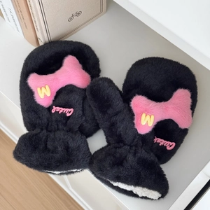 Close-up of black plush mittens with pink bone patches and yellow letter W embroidery