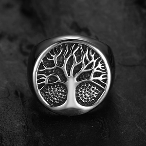 Detailed top view of a vintage stainless steel ring with Tree of Life engraving on dark stone
