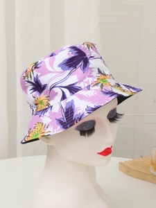 Detailed view of the purple and orange floral print on a reversible sun bucket hat