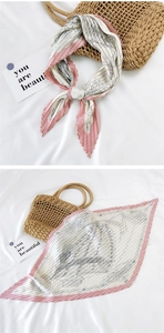 Detail of pleated square silk scarf featuring abstract portrait prints and red dot borders