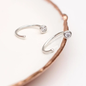 Detailed close-up of S925 silver hoop earrings with a sparkling round zircon stone
