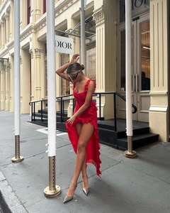 Asymmetrical red midi dress with ruffled edges and high-low hem in street style view