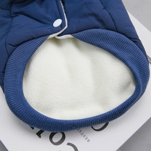 Detail of warm white fleece lining and navy quilted fabric on a pet winter vest
