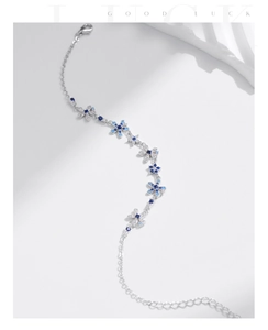 Macro detail of S925 silver flower bracelet with blue gradient zircon inlay craftsmanship