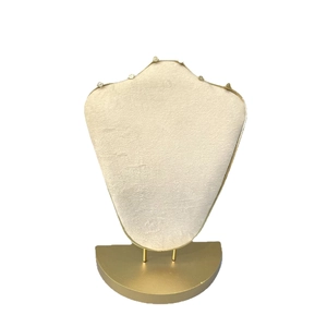 Beige velvet necklace display stand with gold metal base for jewelry presentation