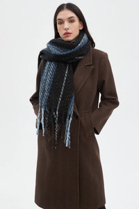 Close-up of dark blue plaid knit scarf with tassels paired with a brown wool coat