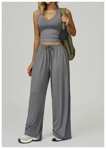 Detail of grey V-neck yoga tank top and drawstring trousers with high elasticity