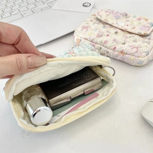 Detailed interior of quilted cartoon card holder showing capacity for cosmetics and coins