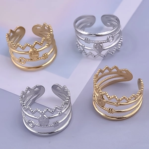 Detailed view of adjustable gold and silver rings with skull and key crown relief