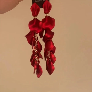 Macro shot of long red silk petal tassel earrings with elegant gold chain links